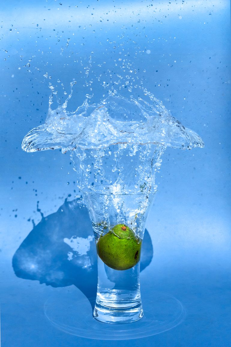 Green Avocado Into Splashing Water